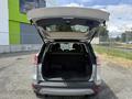 A 2015 Ford Escape with its rear hatch open revealing the spacious interior and cargo area