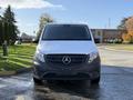A 2020 Mercedes-Benz Metris with a white front and dark lower section facing forward