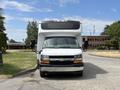 A 2020 Chevrolet Express with a prominent front view featuring a black grille and headlights with side mirrors extending outward