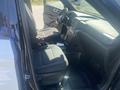 Interior view of a 2020 Ford Explorer showing two front seats and dashboard features with a black and gray color scheme