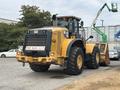 A yellow 2012 Caterpillar 980 wheel loader with a large front bucket and distinctive CAT branding on the side