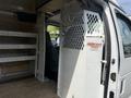A 2008 Ford Econoline van with an interior featuring a partitioned area, shelving on one side, and a weather guard logo on the partition wall