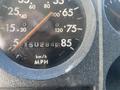 Close-up of the speedometer from a 1997 Freightliner FL70 showing the speed needle at 85 mph along with a mileage reading of 150284