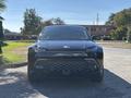 A black 2023 Fisker Ocean SUV seen from the front with a distinctive grille and sleek headlights