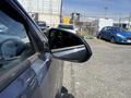 A 2018 Kia Rio5 with a focus on the side mirror reflecting its surroundings