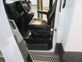 A 2020 Chevrolet Express with an open door showing the driver's seat and interior controls