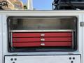 A 2020 Ram 2500 with an open storage area revealing four red tool drawers neatly organized inside