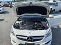 A 2014 Mercedes-Benz CLA-Class with its hood open displaying the engine compartment