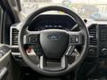 Steering wheel of a 2019 Ford F-350 SD featuring various control buttons and the Ford logo in the center