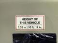 A label indicating the height of a 2017 Chevrolet Express showing 3.32 m and 10 ft 11 in