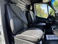 A 2019 Mercedes-Benz Sprinter with two black leather seats in the front cabin area showcasing seat belts and a console with cup holders
