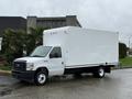 A white 2024 Ford E-450 box truck with a rectangular cargo area and a simple cab design parked on a street