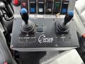 Control panel with two joysticks labeled for plow movement and hoist operation featuring buttons for body up down and brine valve controls