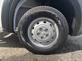 A close-up view of a silver wheel and tire from a 2023 RAM Promaster 3500 with visible tread patterns and a shiny hubcap