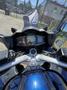 The image shows the dashboard and handlebars of a 2016 Yamaha FJR1300AE motorcycle featuring a digital display and various control buttons
