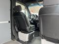 Interior view of a 2025 Mercedes-Benz Sprinter showing the driver's seat and dashboard with a focus on the seating arrangement and controls
