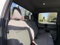 Interior view of the back seat of a 2021 Ford F-250 SD with grey cloth upholstery and headrests visible