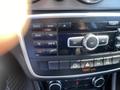Dashboard controls of a 2014 Mercedes-Benz CLA-Class featuring buttons for radio navigation and climate settings