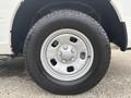 Close-up of a silver alloy wheel with a black tire from a 2016 RAM 1500