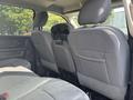 Interior view of the back seats in a 2013 RAM 5500 with two gray upholstered seats and a central armrest mounted on the back of the front seats