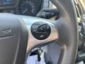 A close-up of the steering wheel control panel of a 2019 Ford Transit 350 showing buttons for audio and cruise control