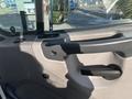 Interior door handle of a 2022 Freightliner M2 106 truck with a textured surface and black finish