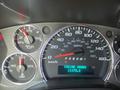 The dashboard of a 2020 Chevrolet Express showing speedometer fuel gauge and engine hour display with illuminated indicators