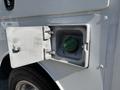 Fuel access door of a 2011 Ford F-550 revealing a green diesel fuel cap