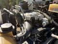 Close-up of the engine compartment of a 2013 International CE300 showing various hoses pipes and components without any visible branding