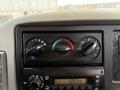 Dashboard controls of a 2011 International 4300 featuring knobs for climate control and a radio display showing the time as 1223