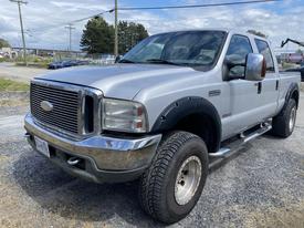 A silver 2007 Ford F-350 SD pickup truck with a crew cab and large tires