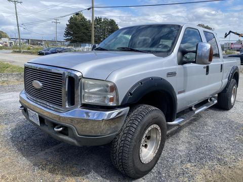 A silver 2007 Ford F-350 SD pickup truck with a crew cab and large tires
