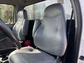 Interior view of a 2018 Ford F-750 featuring two gray leather front seats with a textured pattern and a steering wheel visible in the foreground