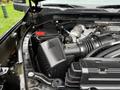 Close-up of the engine compartment of a 2022 GMC Sierra 3500HD showcasing the air intake system and various engine components