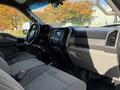 Interior view of a 2019 Ford F-550 with gray fabric seats and a modern dashboard featuring a touchscreen display and various control buttons