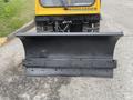 A 2004 Bombardier SW48 snowplow blade designed for removing snow with a wide, curved metal edge and multiple mounting holes for attachment to the vehicle