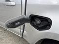A silver 2018 Chevrolet Colorado with the fuel door open revealing the gas cap inside