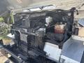 A 2012 Ford Econoline with its hood open displaying the engine compartment showing various components including the radiator and coolant reservoir