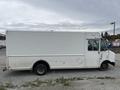 A white 2011 Ford Econoline box truck with a large cargo area and a sliding side door