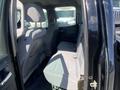 The interior of a 2014 GMC Sierra 1500 showcasing the rear seating area with two fabric-covered bench seats and a spacious layout