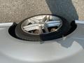 A silver 2013 Mercedes-Benz C-Class with a spare tire mounted on the trunk area