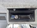A close-up view of an Alpine car stereo mounted in the dashboard of a 2010 New Holland T4050 tractor