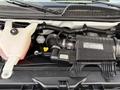 A 2015 GMC Savana engine showing various components including the air intake system and coolant reservoir