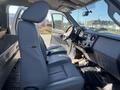 Interior view of a 2016 Ford F-250 SD showing the front seats and dashboard with a gear shift and controls in a light gray color scheme