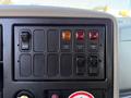 Control panel of a 2010 International 4300 featuring various switches and buttons for vehicle functions