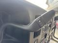 Close-up of the control lever for the cruise control system in a 2018 Chevrolet Express featuring buttons for increasing and decreasing speed