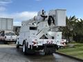 A 2011 International 4300 bucket truck with an elevated boom and platform at the rear, designed for aerial work and maintenance tasks
