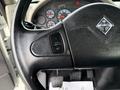 Close-up of the steering wheel of a 2011 International 4300 featuring a cruise control switch labeled "ON" and "OFF"