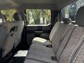 Interior view of a 2017 Ford F-550 showing the backseat area with textured fabric upholstery and seat belts