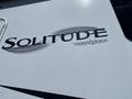 Close-up of the logo on a 2021 Grand Design Recreational ST3478MBS displaying the word Solitude in stylized lettering